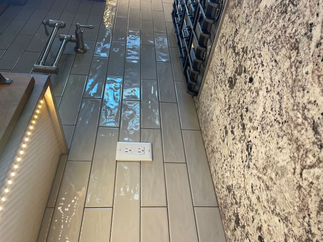 Ceramic subway tile backsplash closeup with stone countertops. 